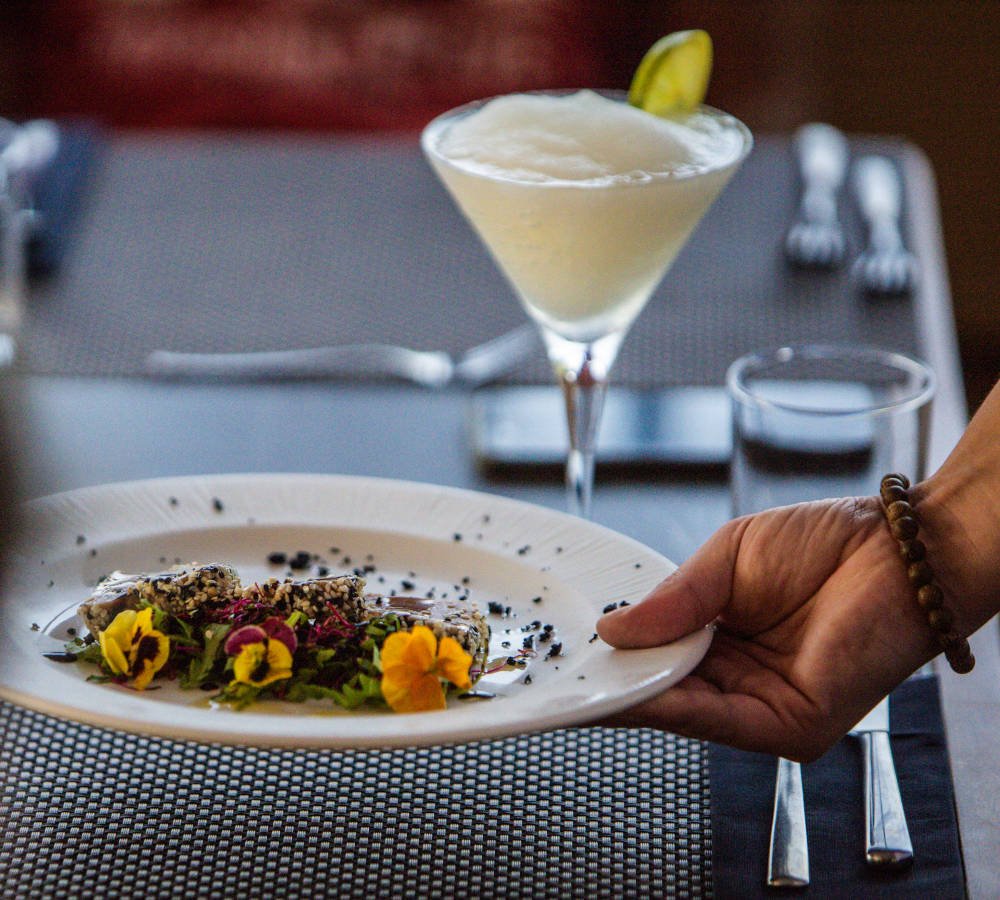 Plated dish and cocktail served in the yacht dining room