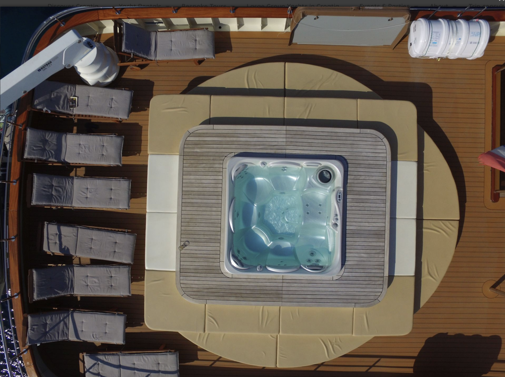 Yacht sun deck with hot tub and sun loungers, seen from above