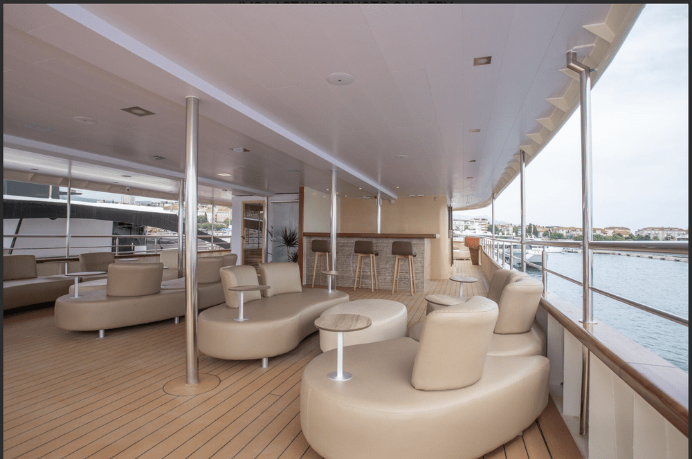 Yacht outdoor lounge with sofas and harbor views