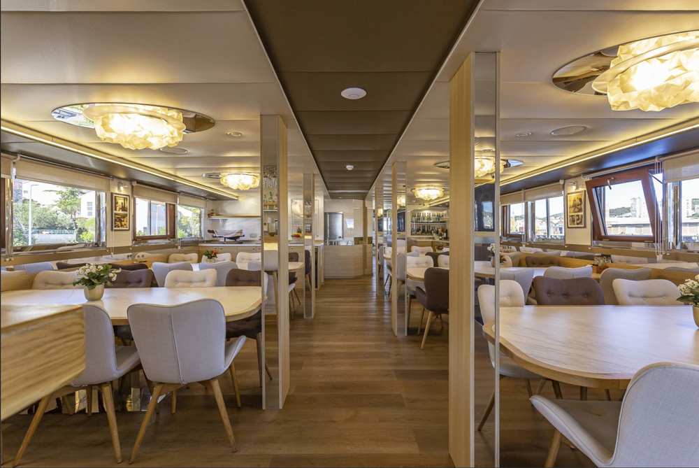 Yacht restaurant with wood floors and tables for guests