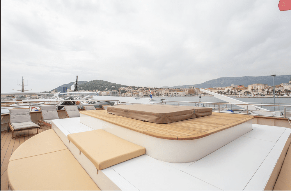 Yacht sun deck lounge with a view of a Croatian harbor town