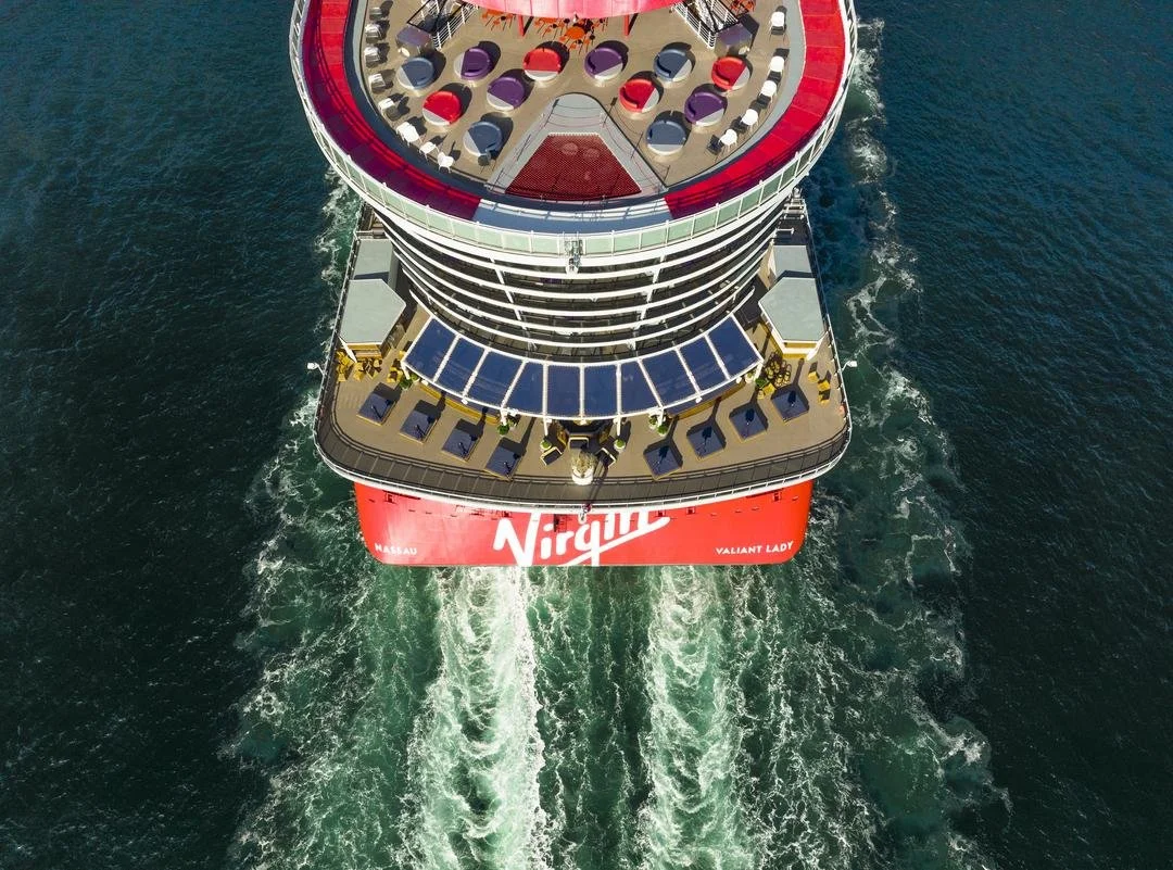 Virgin Voyages ship Valiant Lady seen from above, sailing across open water