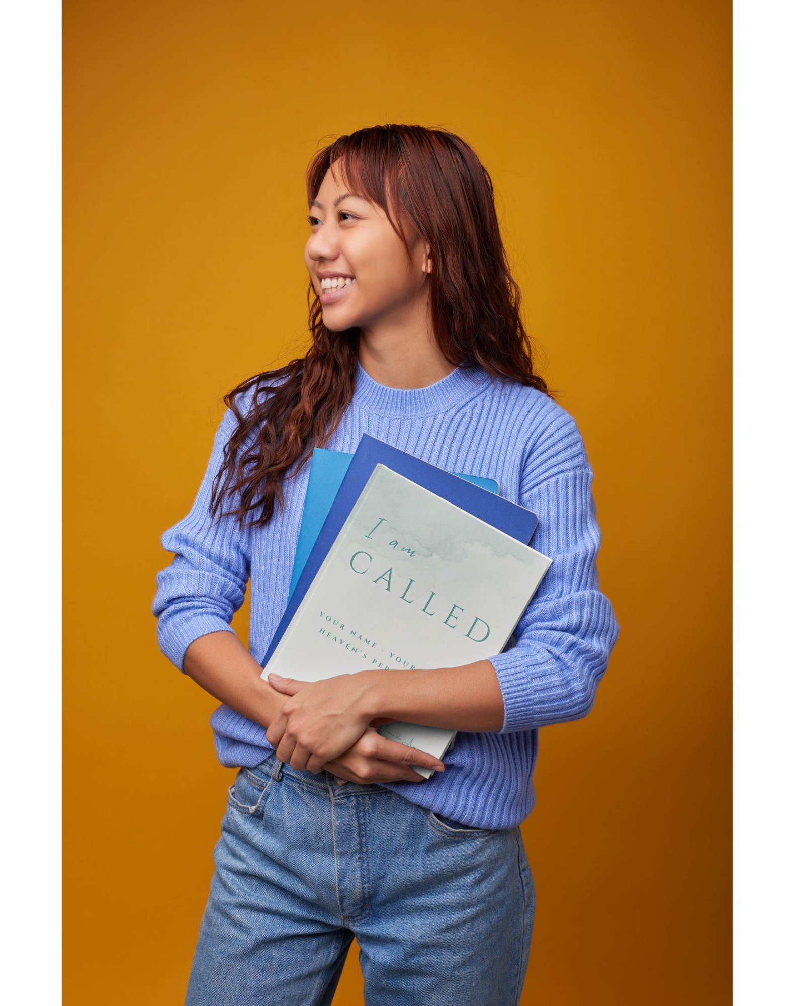 Woman smiling while holding the I Am Called course workbook
