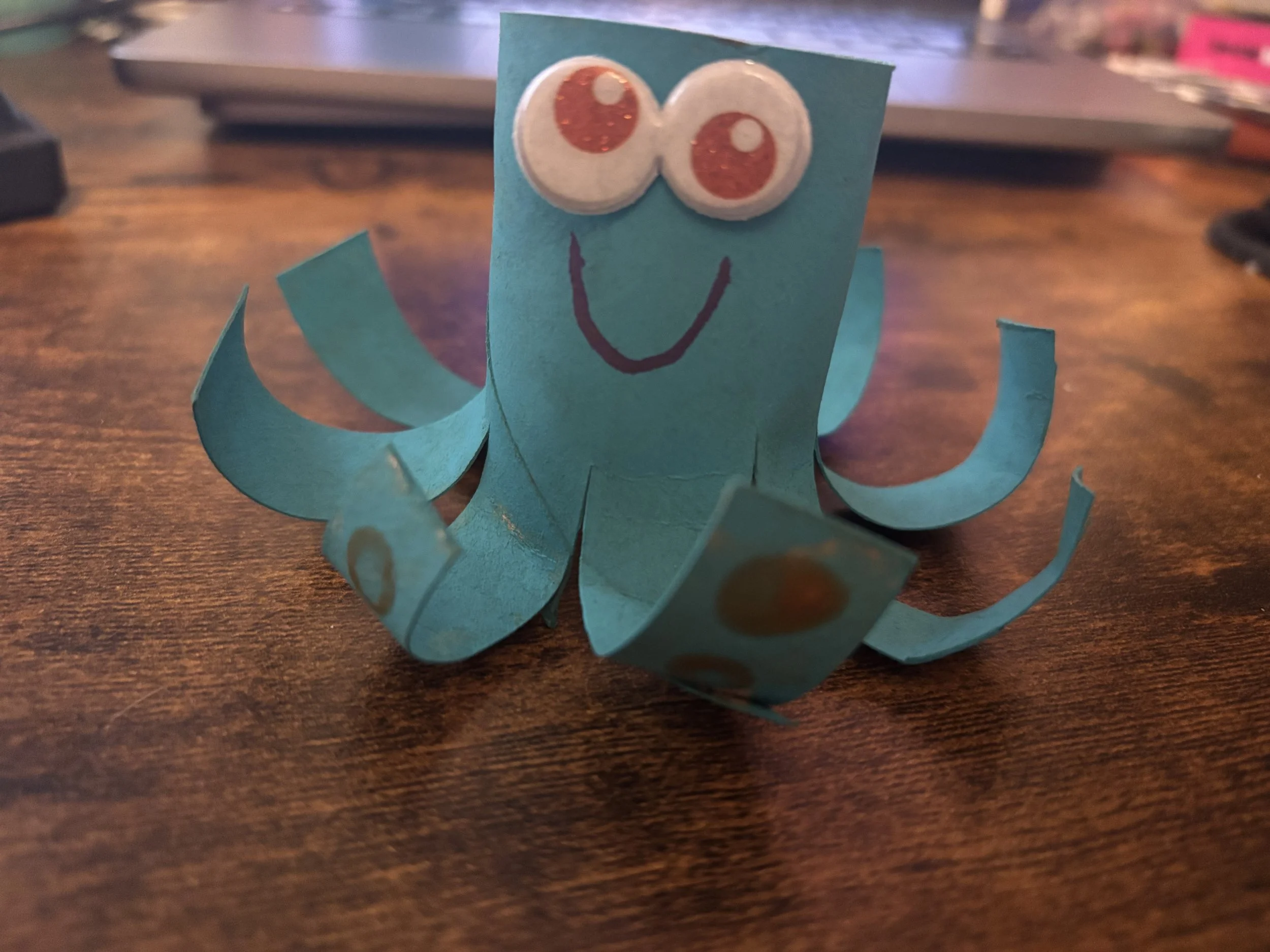 A blue octopus made from a cardboard tube