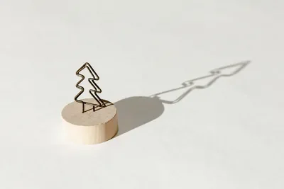 A small decorative metal tree casting a long shadow