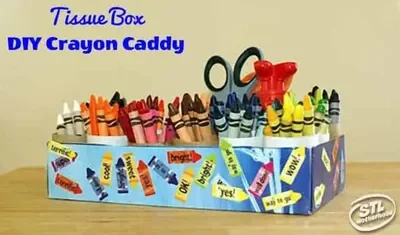 Crayons organized by color in tubes placed inside a tissue box