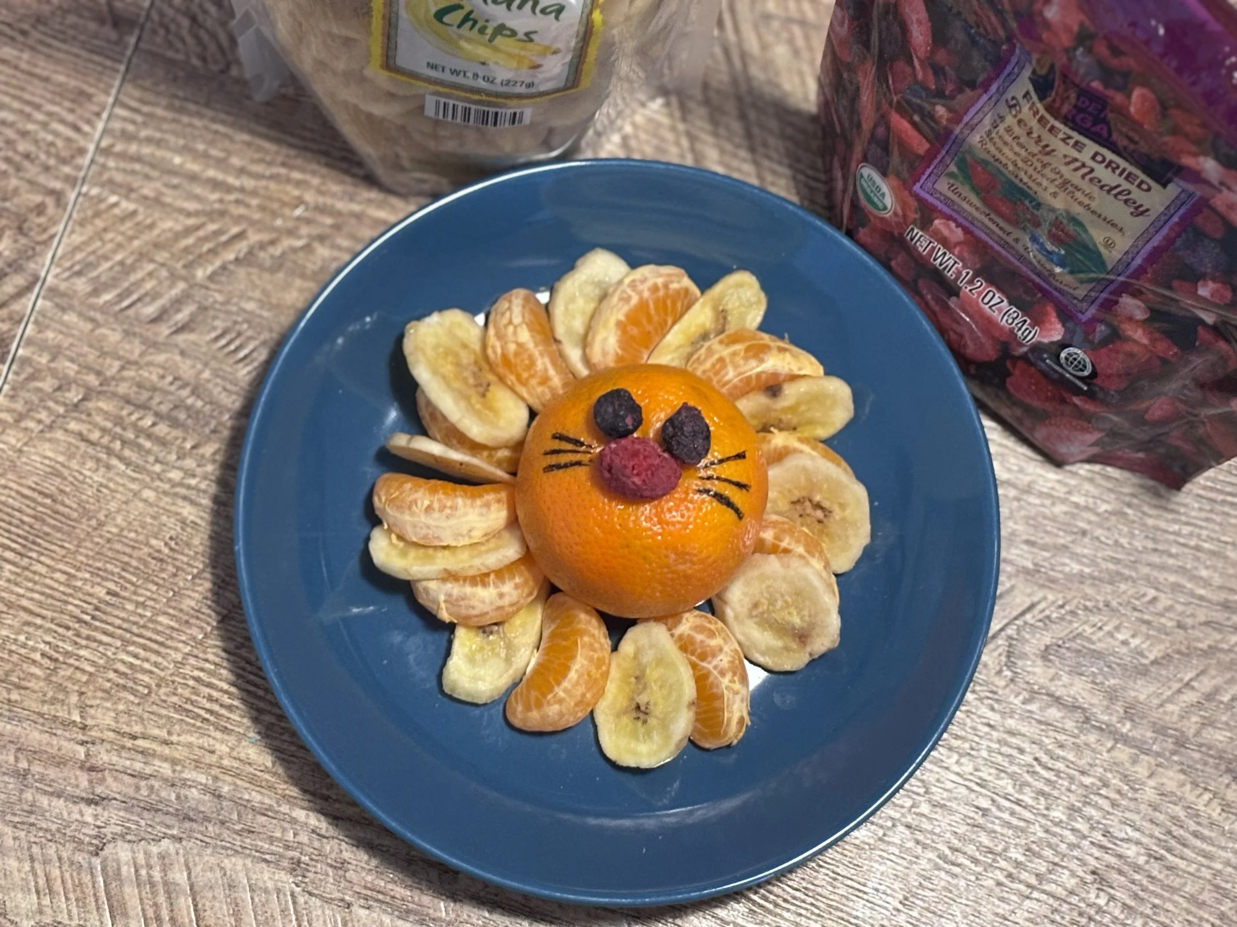 A lion snack plate made from oranges and dried fruit