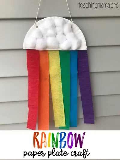 A rainbow craft made from crepe paper streamers, half a paper plate, and cotton balls