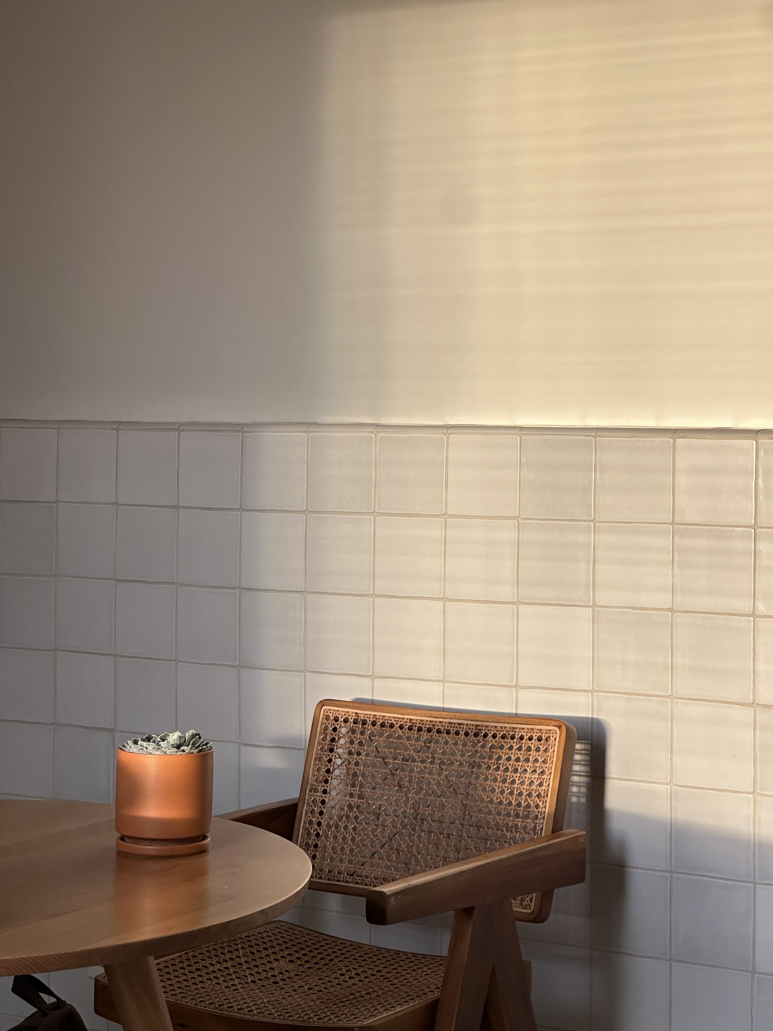 Round dining and workspace table inside SANTO in San Felipe Baja California designed for remote work, featuring a clean minimalist setup suited for digital nomads.