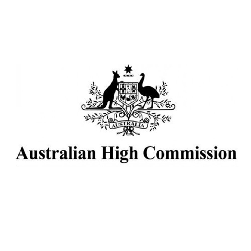 Black and white logo of the Australian High Commission, featuring a shield with the Australian coat of arms, a kangaroo and an emu, surrounded by decorative foliage.