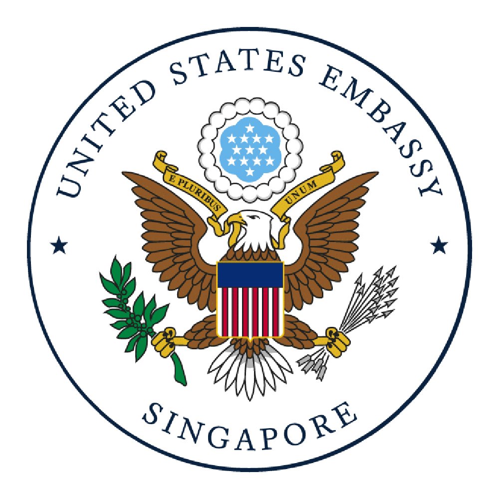 Seal of the United States Embassy in Singapore featuring a bald eagle holding an olive branch and arrows, with a shield on its chest, and a ring of stars above.