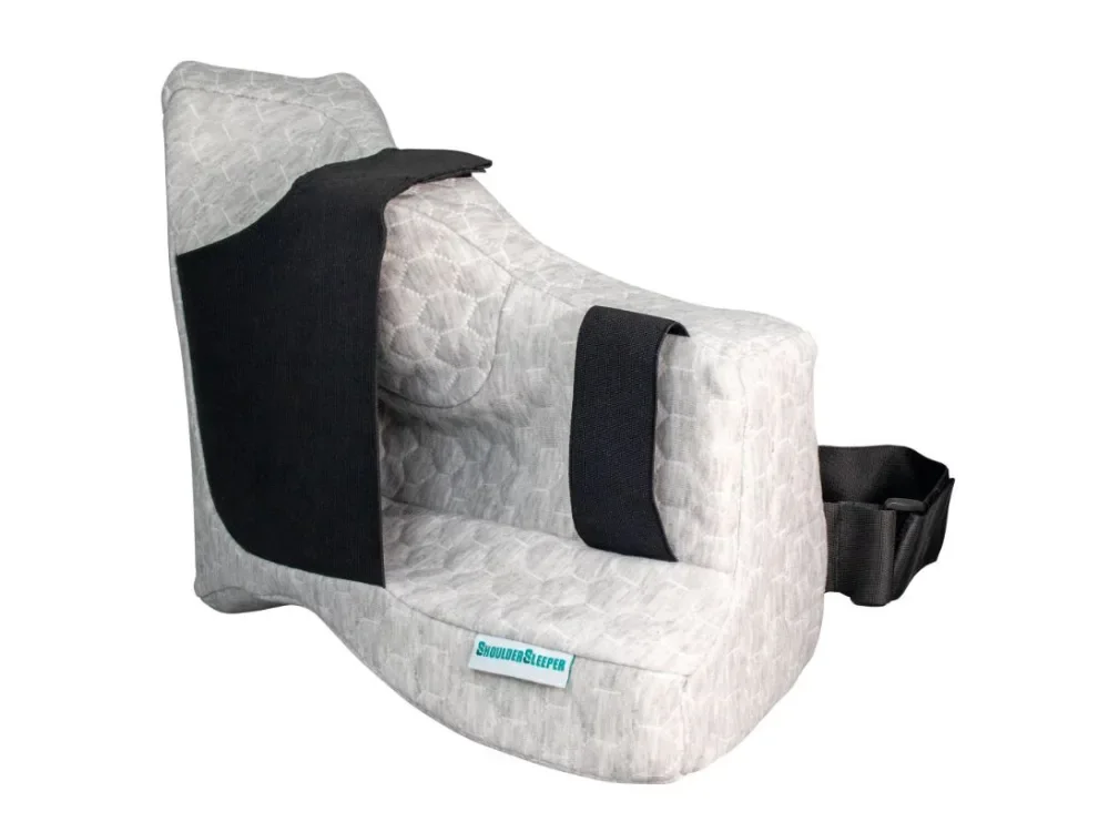 A gray quilted baby car seat with black shoulder straps and a black waist strap.