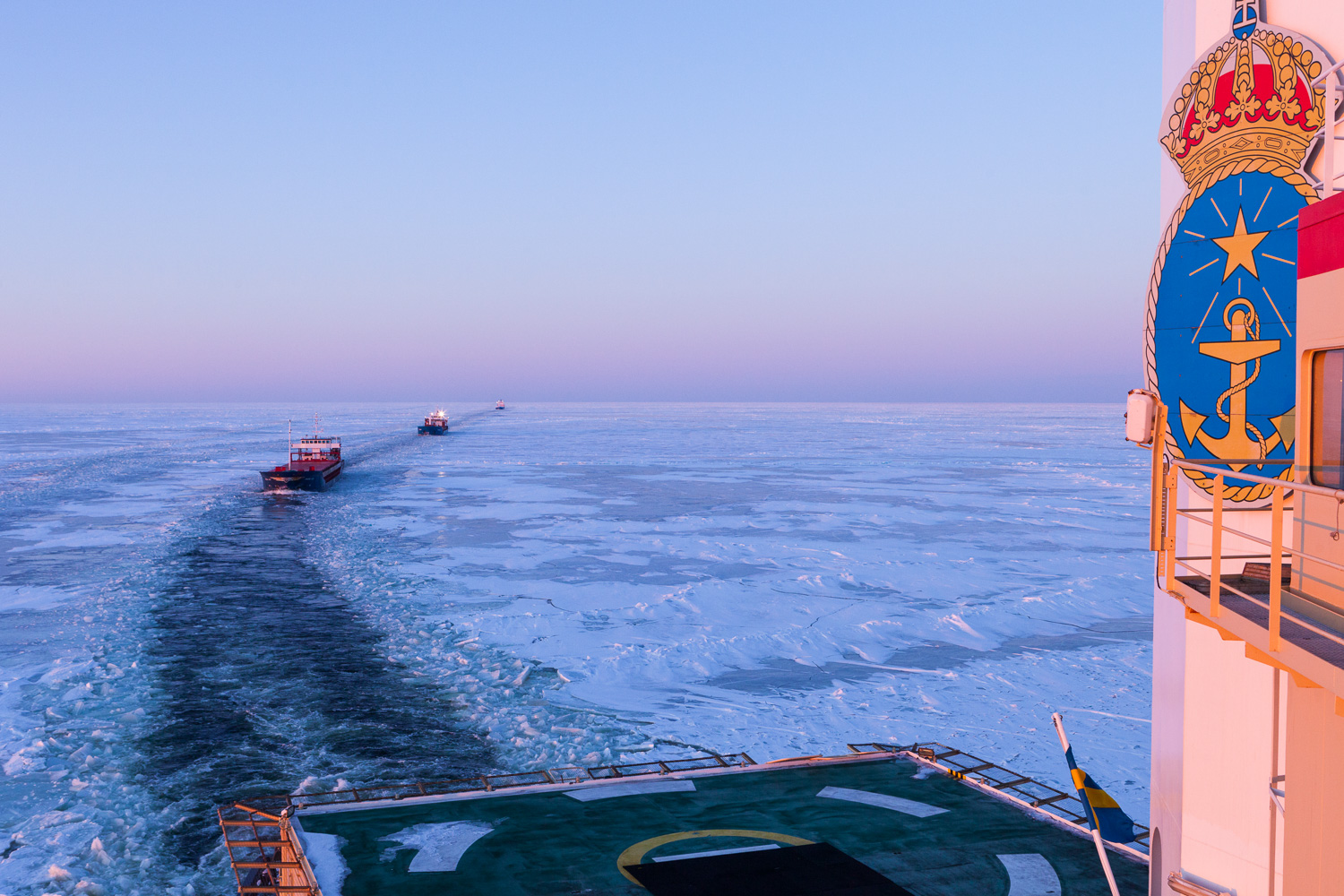 Many fisheries are entirely dependent on icebreakers to keep the shipping lanes open. A string of ships follow Odin in convoy through the ice.