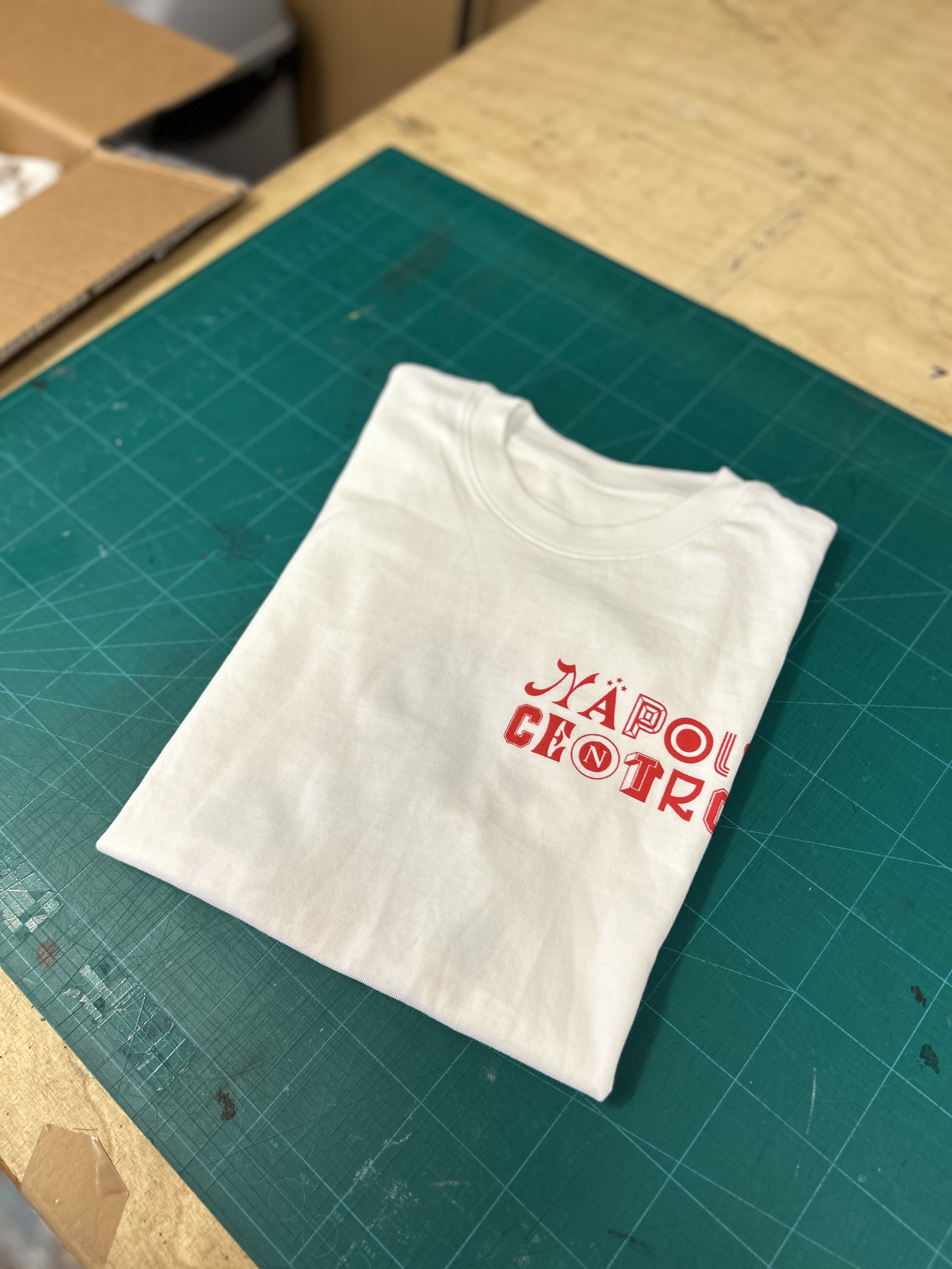 Pocket logo on off white tees for Napoli Centro pizzeria.