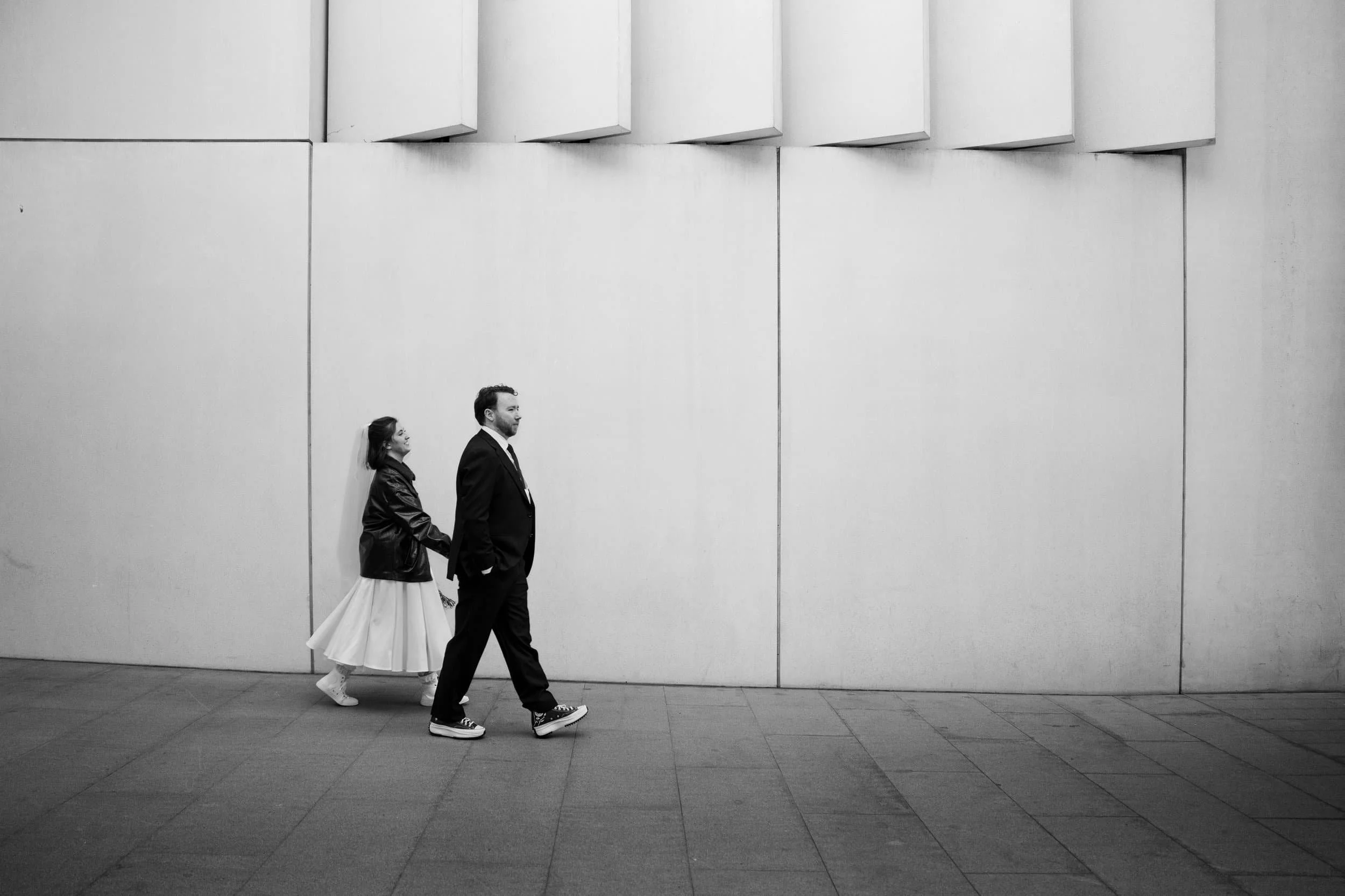 Bride and Groom walking hand in hand after their ceremony at Marylebone Town Hall