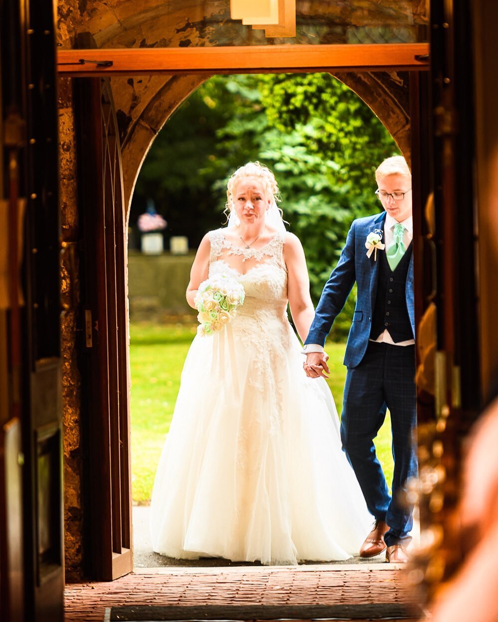 Beautiful shot of the bride just before she enters the church, being accompanied by her son. We love the emotion in this photograph. #hsphotographyuk #lincolnshireweddingphotography