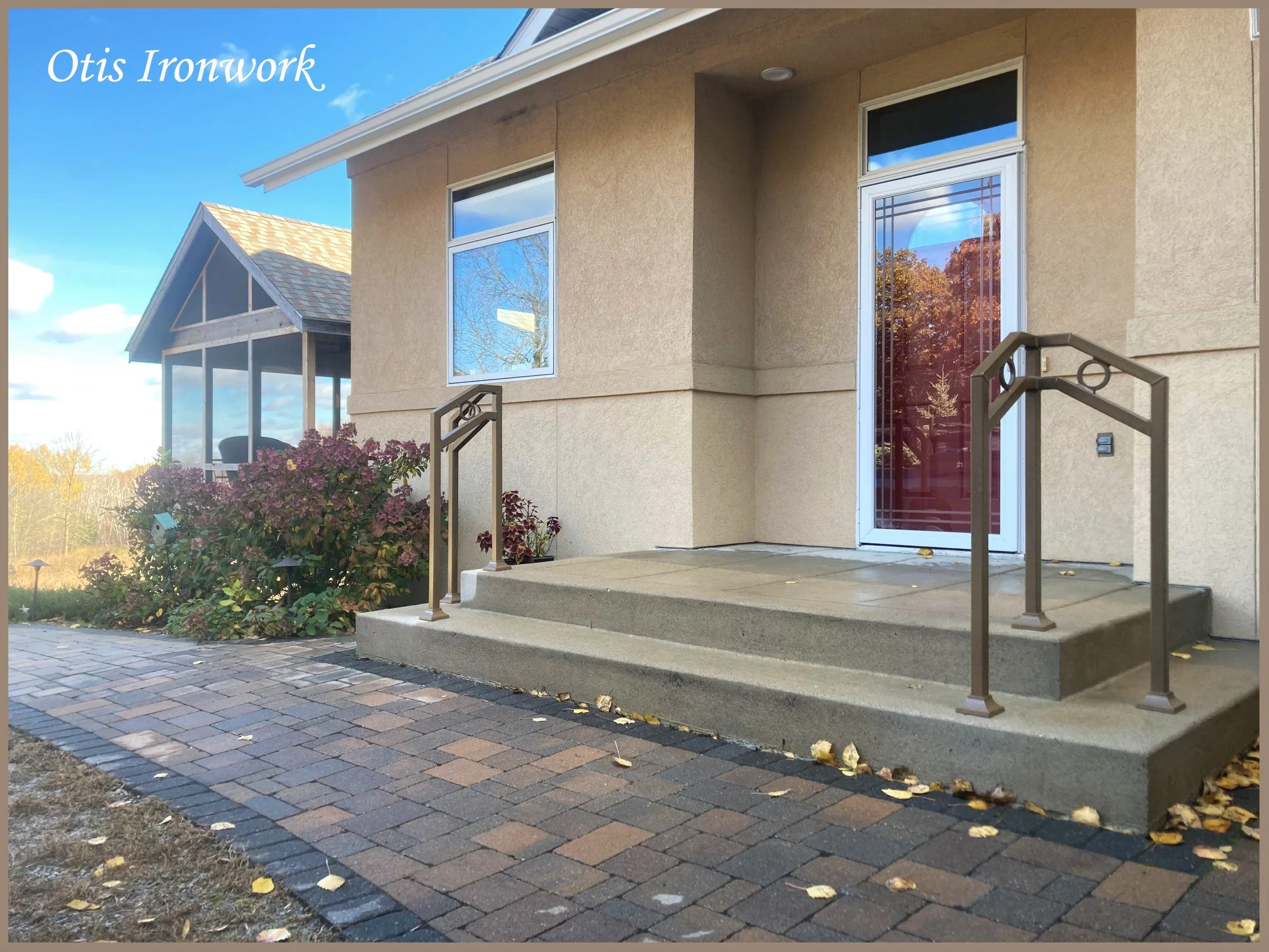 Modern handrails with circle design. Custom railings handcrafted in Minnesota by Otis Ironwork. Welded from quality materials including a durable powder coat paint finish and professional installation. Call Otis Ironwork at 507-995-3745 to get your r