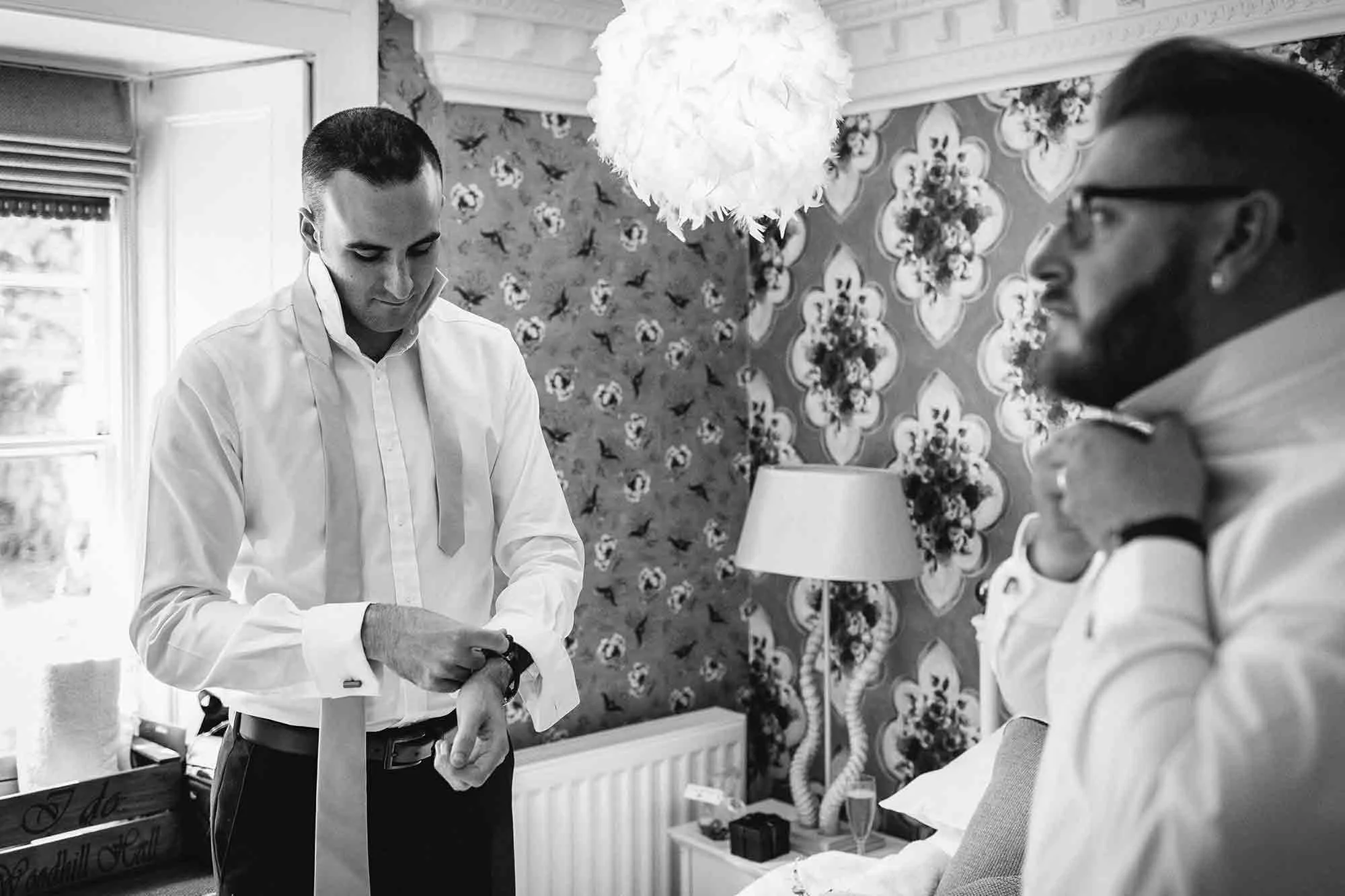 The groom and his best man getting ready for his wedding at Woodhill Hall.