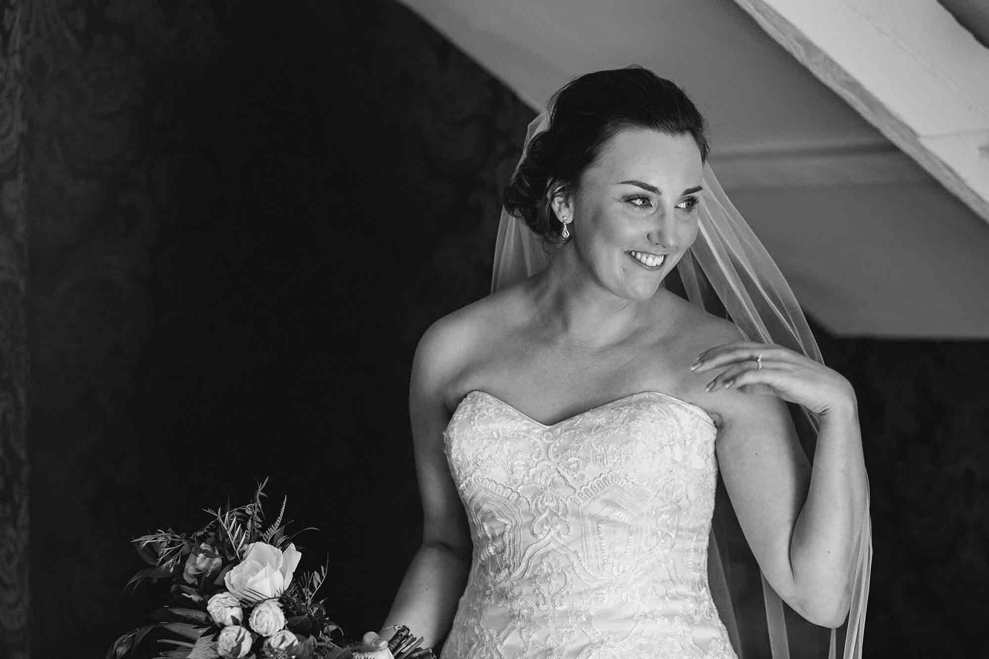 The bride smiles towards her parents at Woodhill Hall just before her wedding.