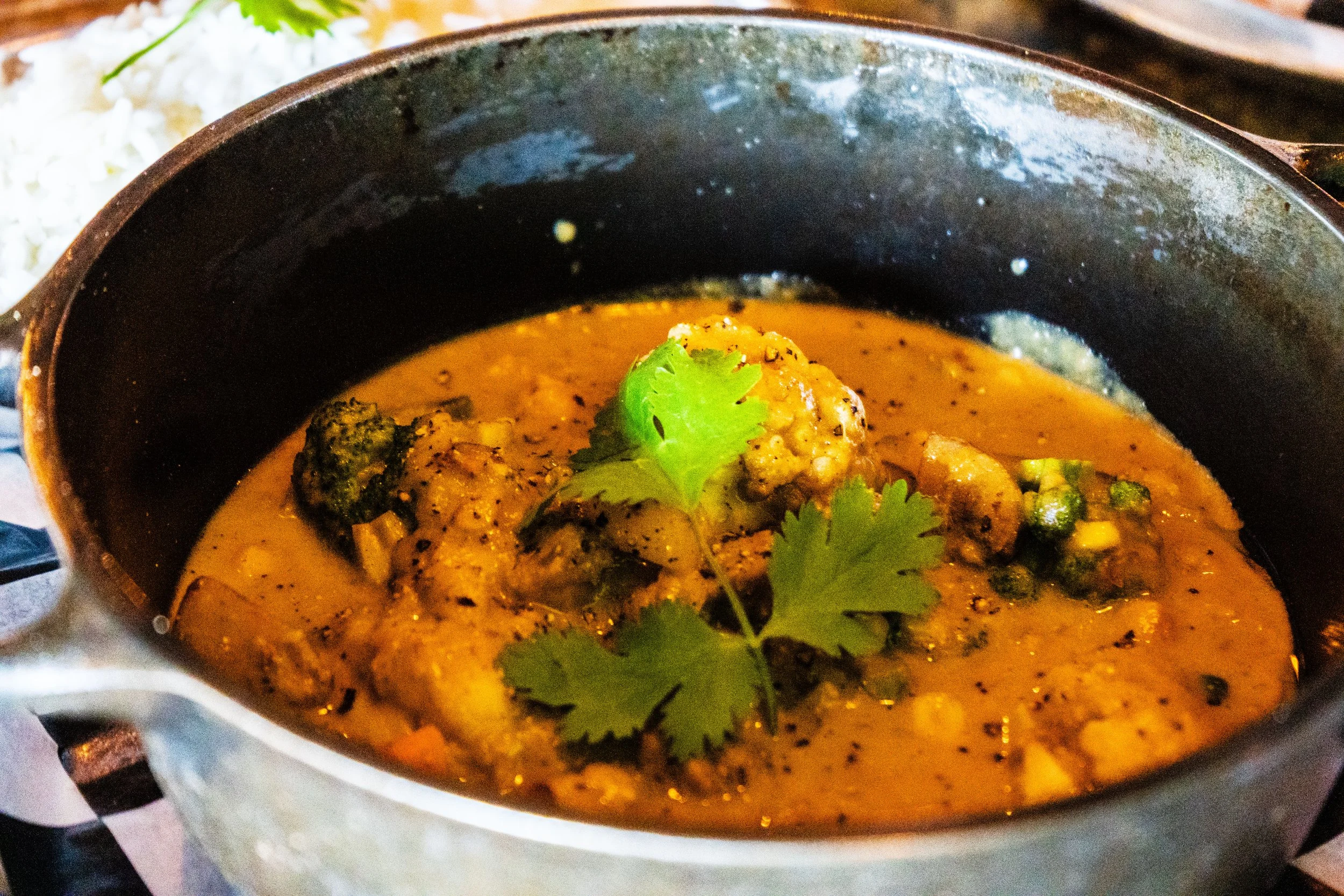 Vegetable curry with cilantro in a pot.
