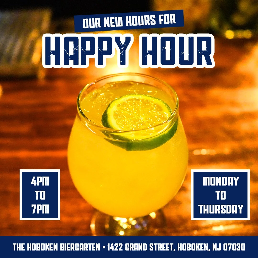 Glass of beer with lime on a wooden table. Text: "Our New Hours for Happy Hour" with details: Monday to Thursday, 4 PM to 7 PM at The Hoboken Biergarten, 1422 Grand Street, Hoboken, NJ 07030."