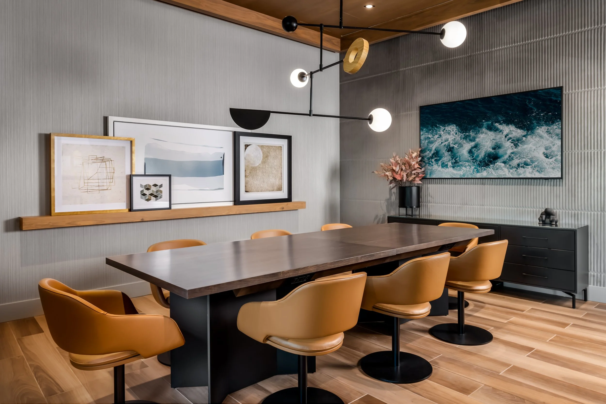 Boardroom with leather chairs, feature artwork, and large wood table