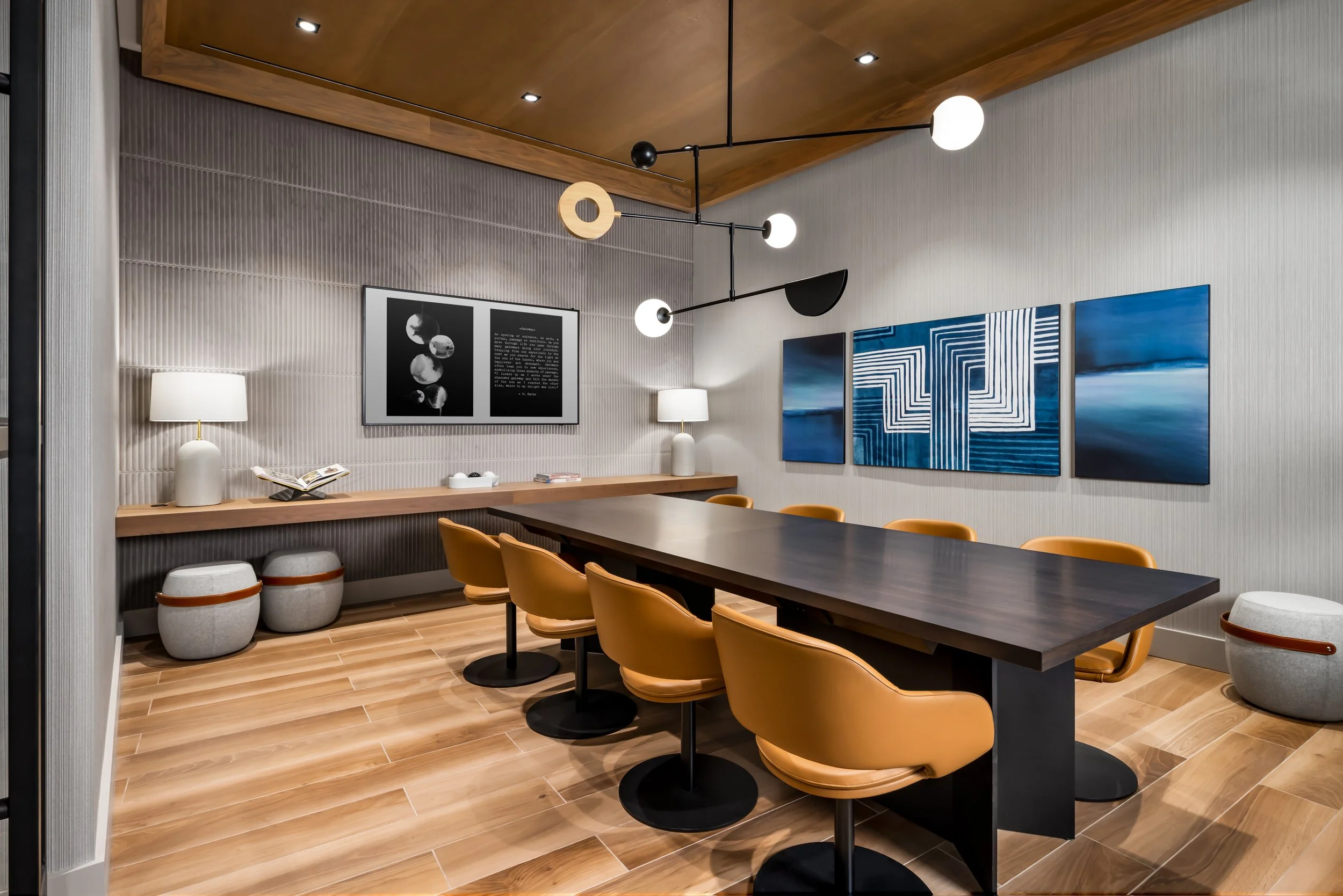 Boardroom with leather chairs, feature artwork, and large wood table