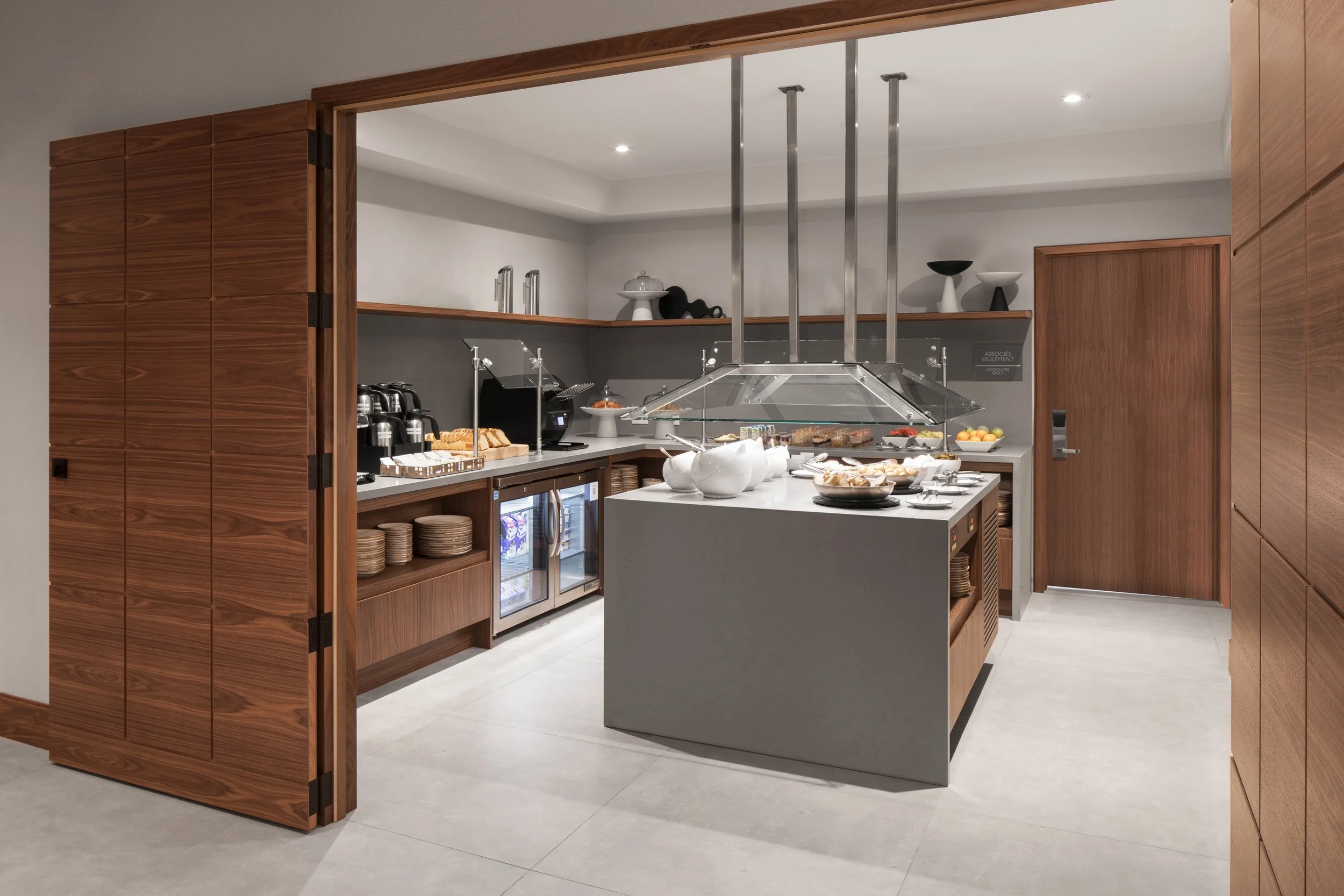 Buffet food service space with quartz countertops and wood millwork