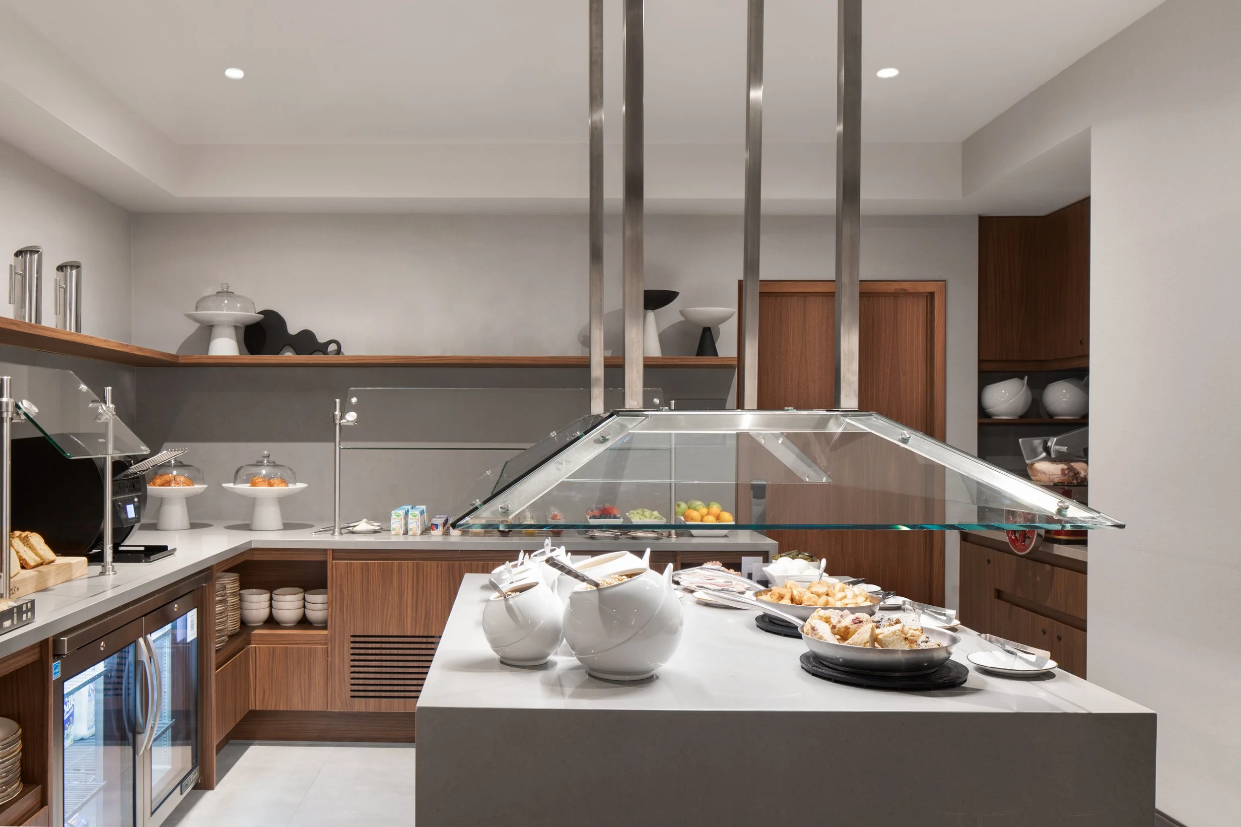 Buffet food service space with quartz countertops and wood millwork