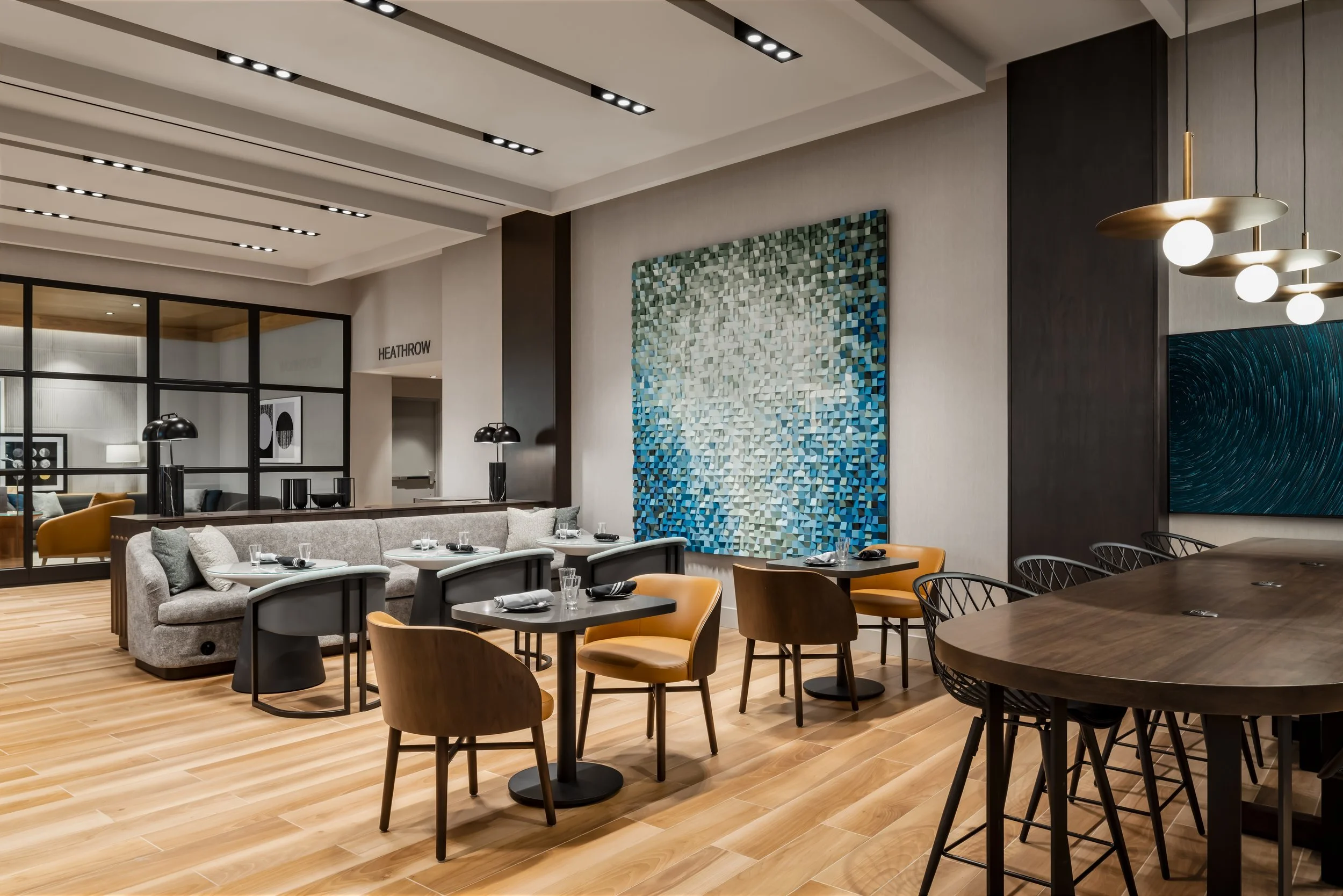 Hotel restaurant area with various seating and feature painted wood block artwork