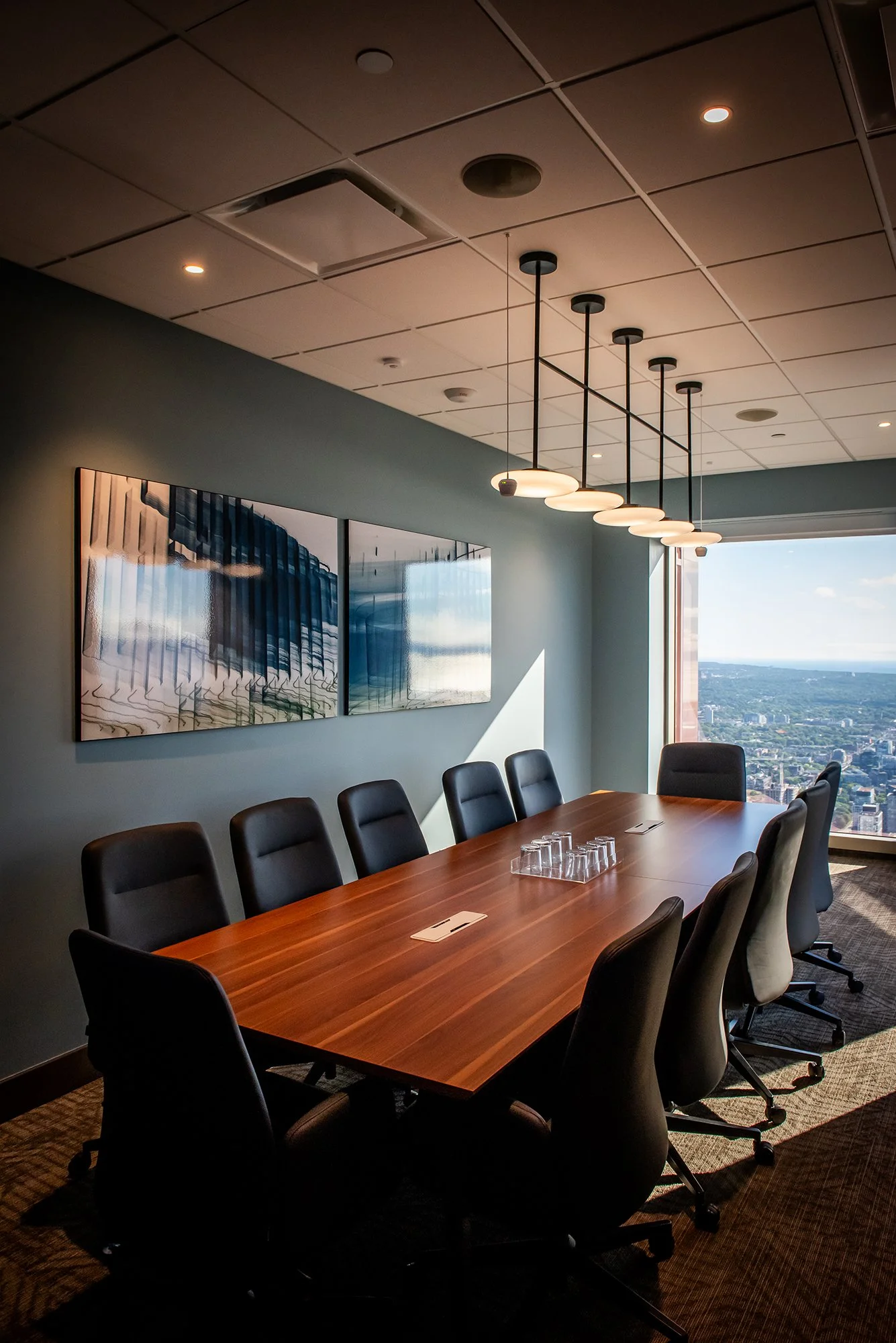 Meeting room with large wood boardroom table and chairs