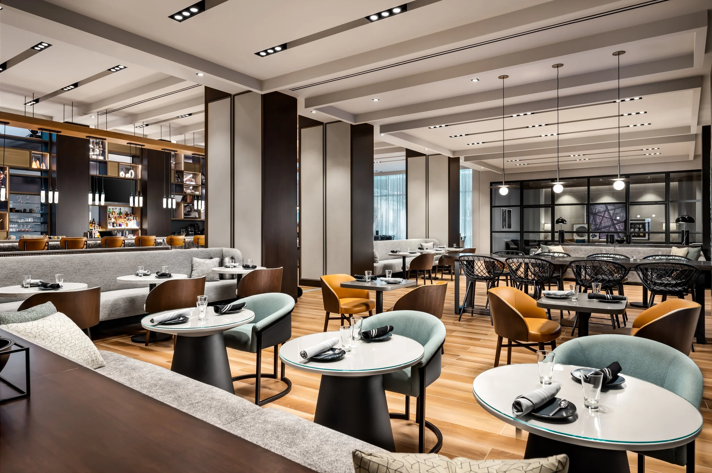 Hotel restaurant area with bar beyond