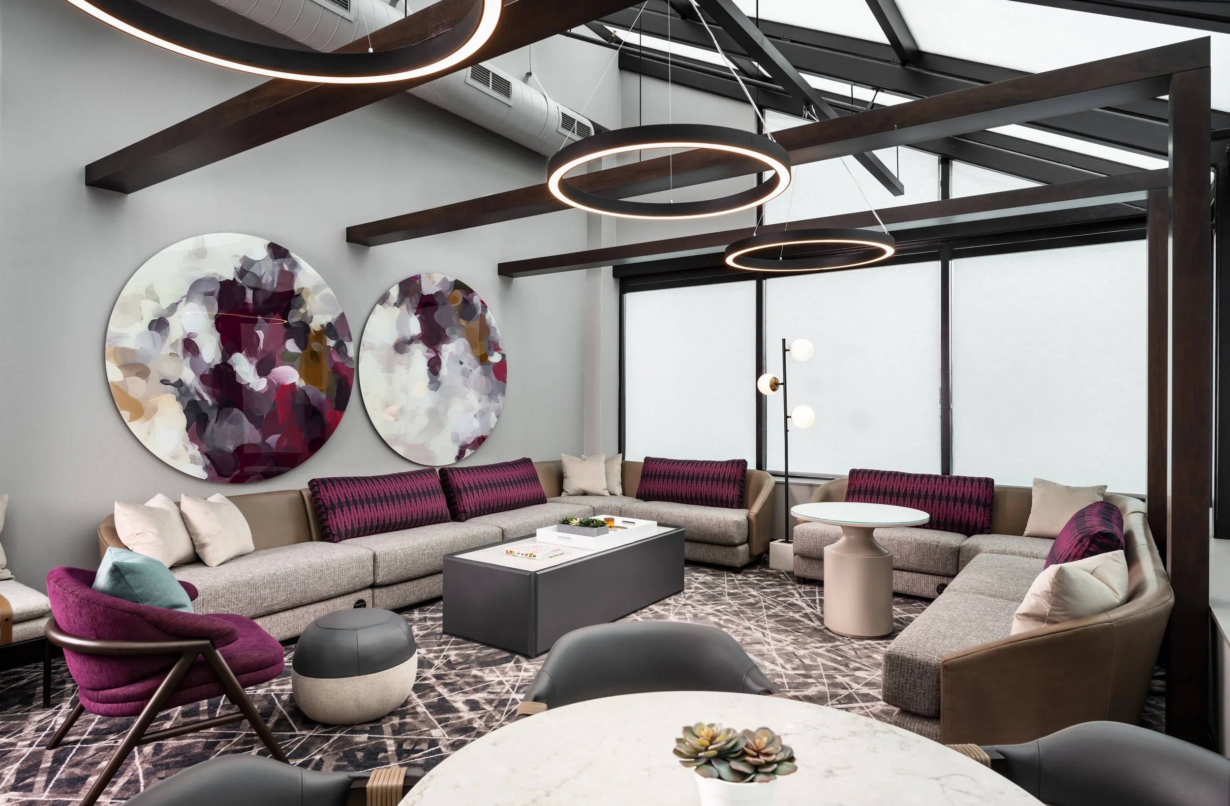 Club lounge solarium space with various seating and feature artwork