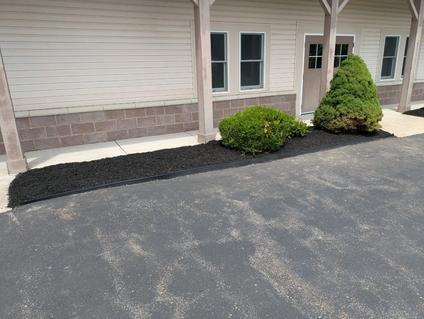 A landscape project from early June. This project included installing new landscape edging, a fresh layer of mulch, and the removal and re-planting of two boxwoods.