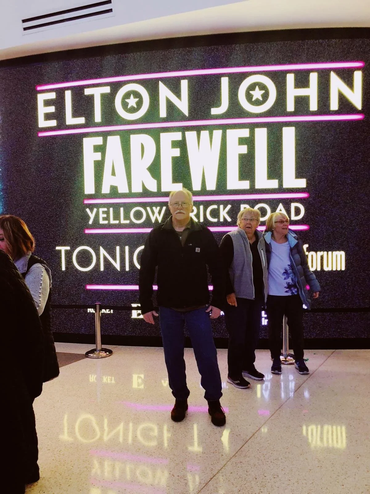 Dopa Dreams participant and Parkinson's warrior Jeff, smiling with his wife, as they attend an Elton John concert - Jeff's dream experience come true.