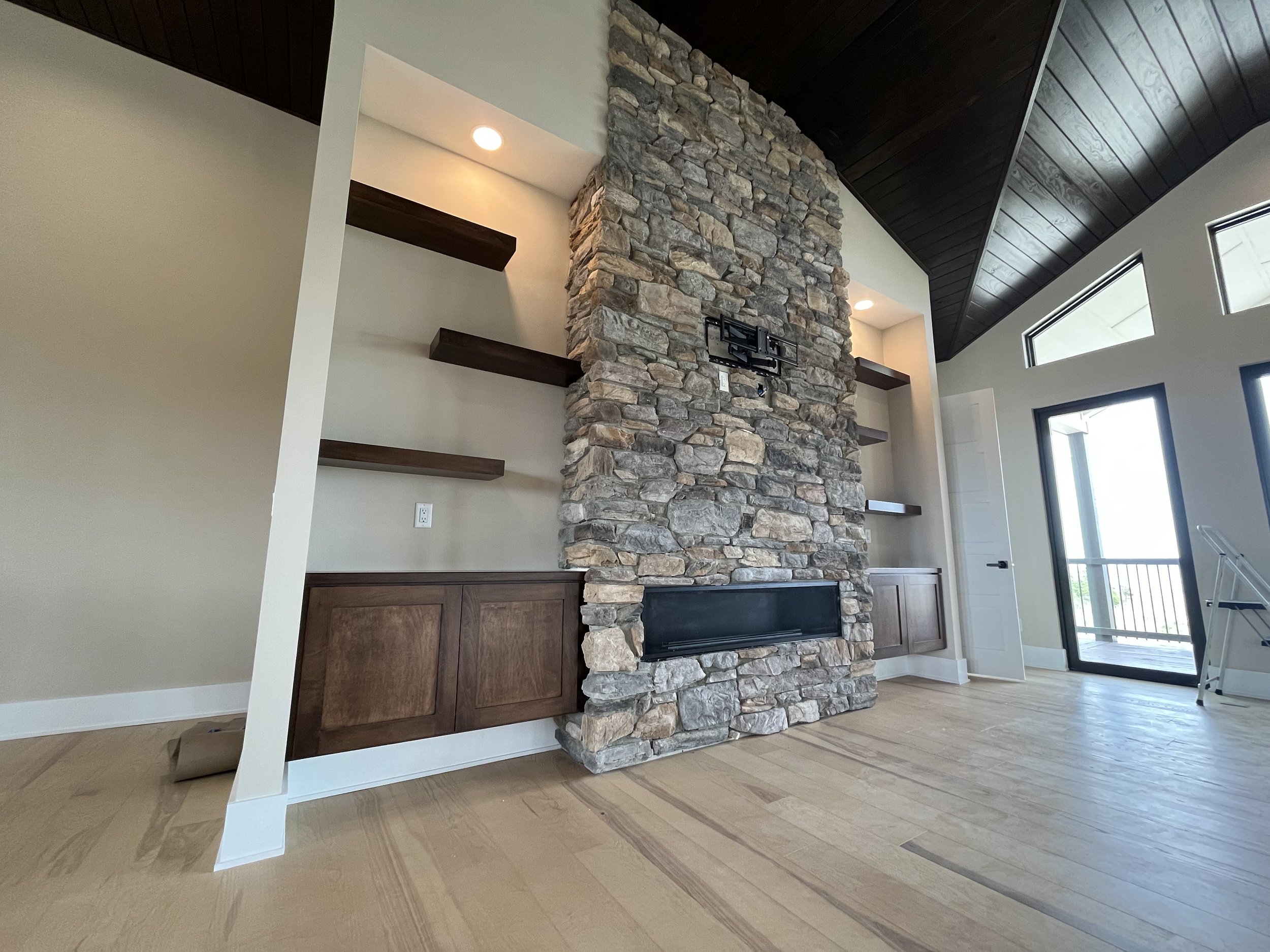Beautiful Stone Mantle and Floating Wood Shelves