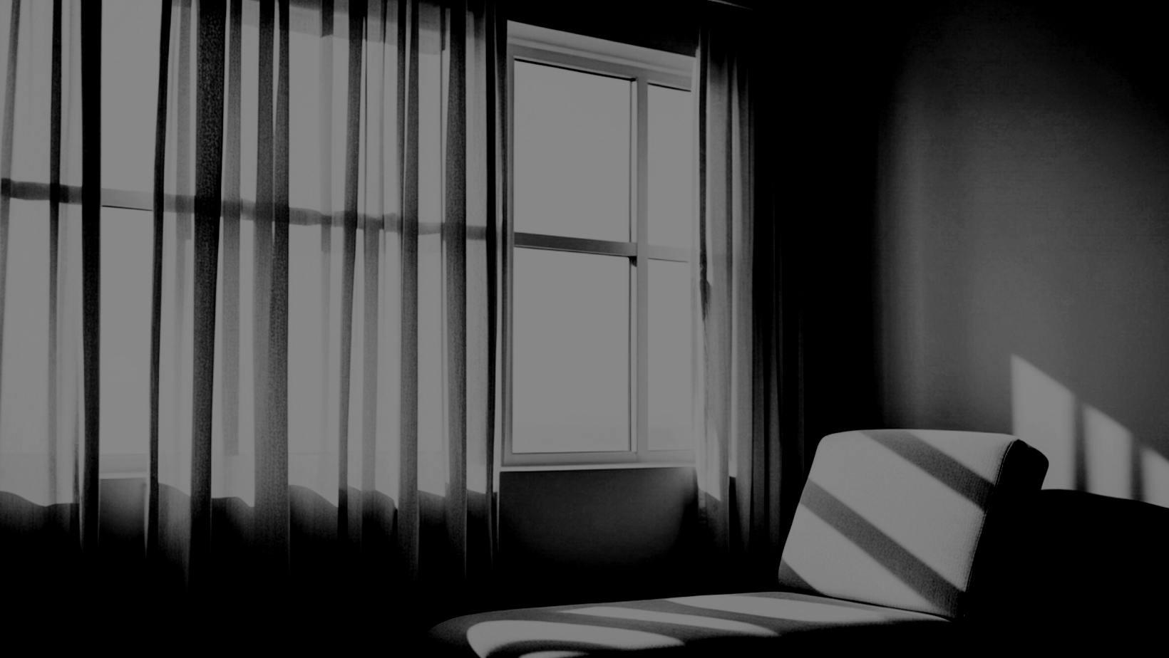 A black and white photo of a window with curtains and sunlight casting shadows on a chair and wall inside a room.