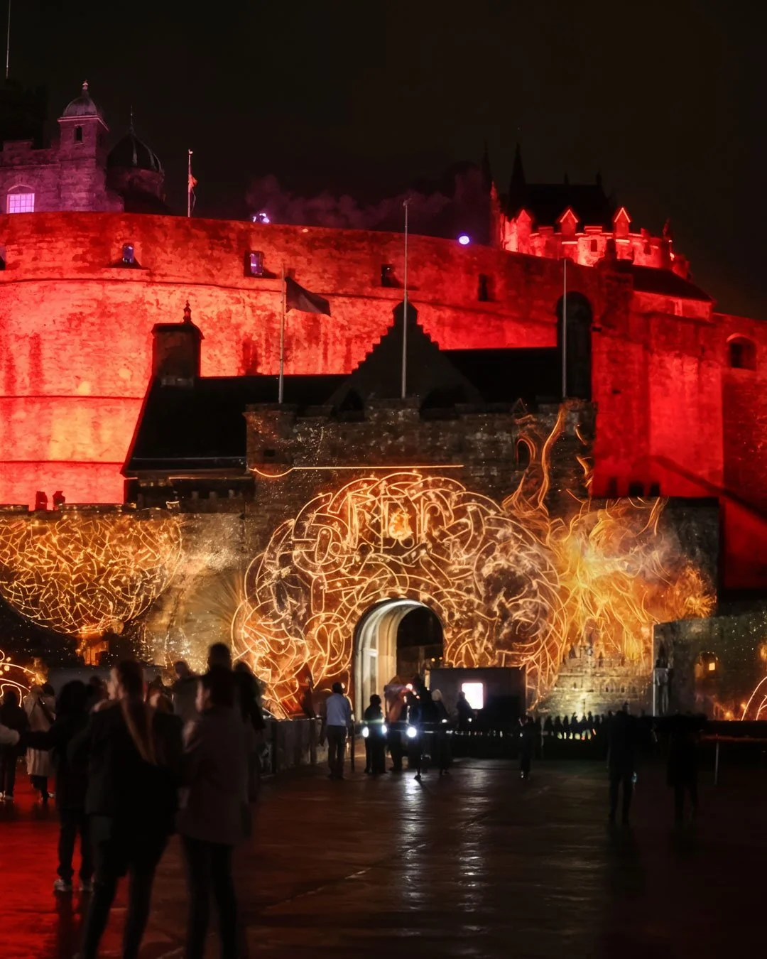Projection mapping animation on Edinburgh Castle during a large-scale outdoor light show.