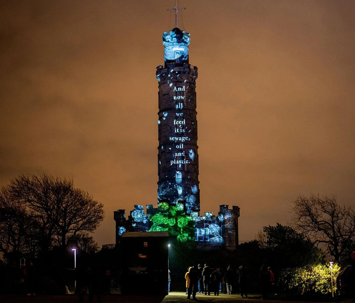 isitors assemble on Calton Hill to witness a dazzling light projection display across Nelson’s Monument after dark.