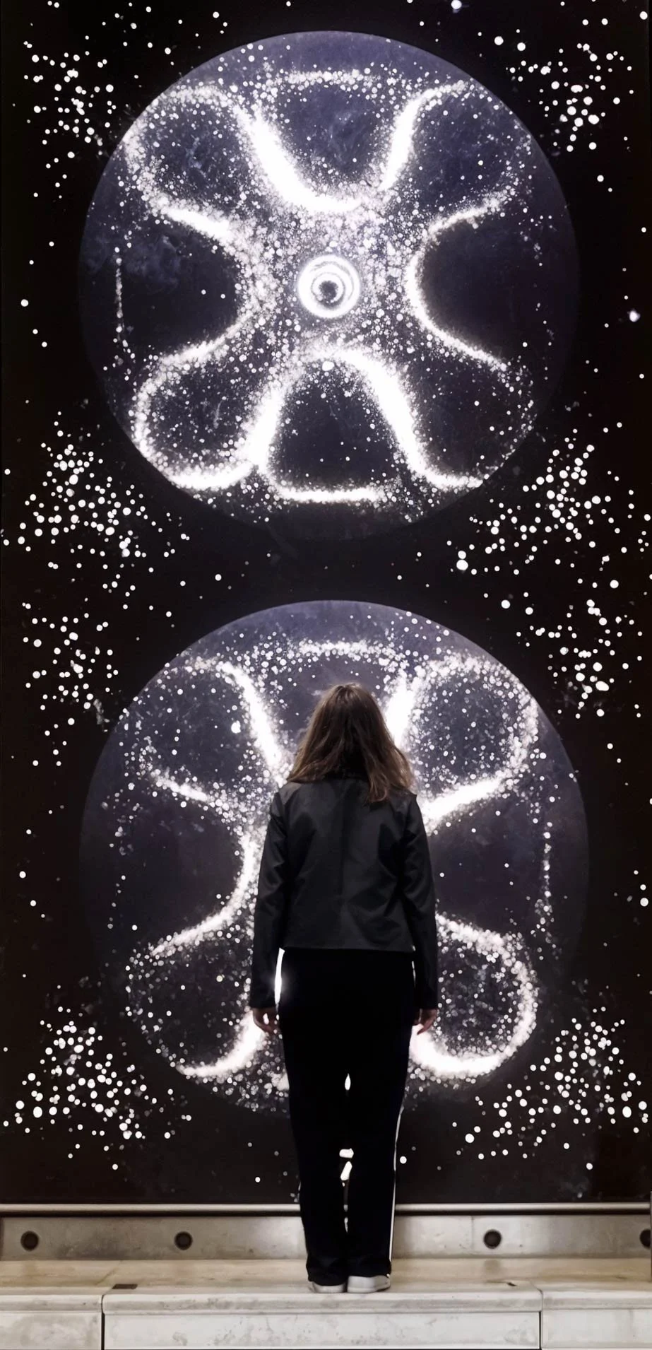 Visitor viewing the Chladni Plate digital art installation on the large-scale LED screen at Aberdeen Music Hall