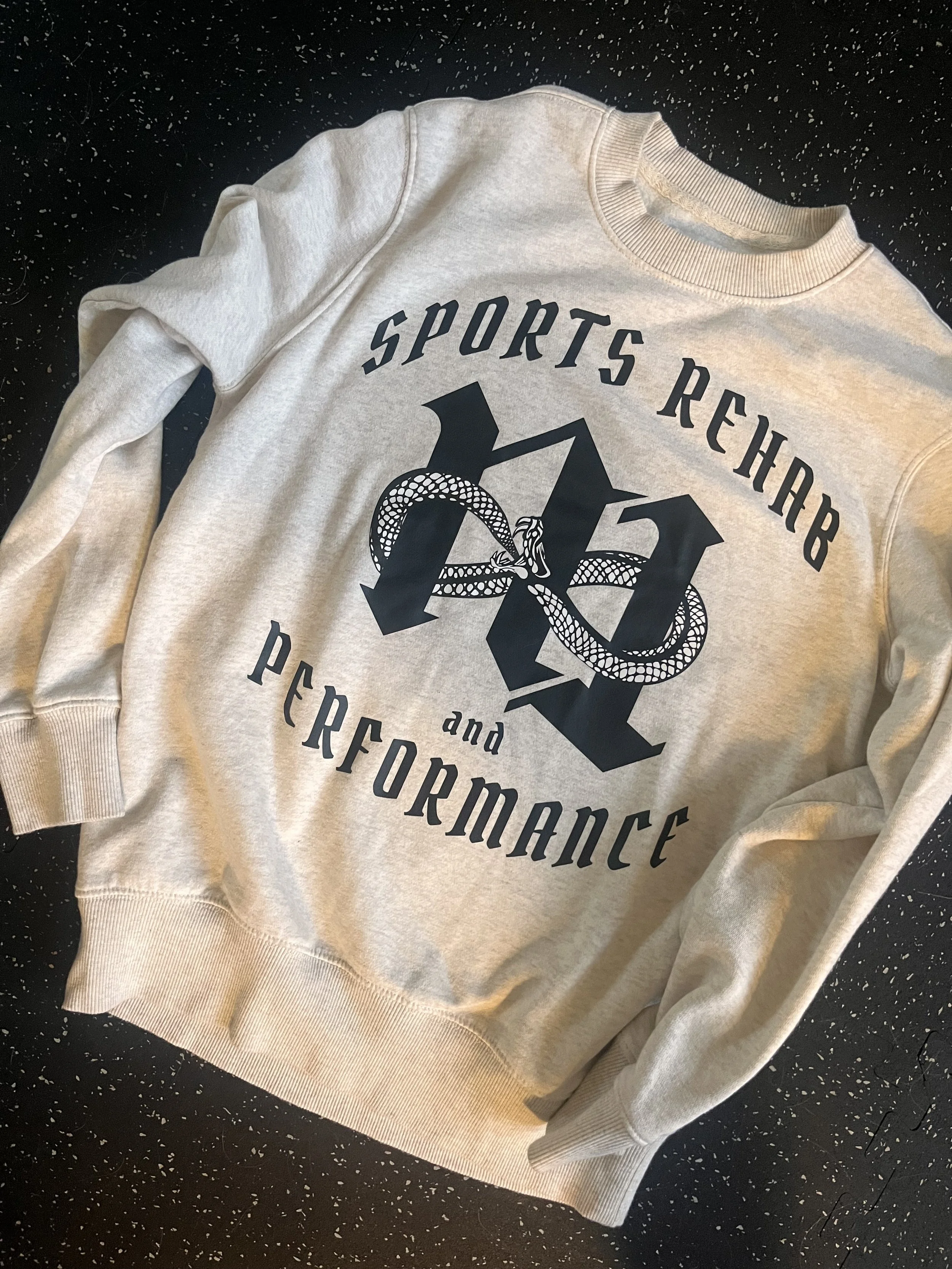 cream n1 sweatshirt against gym floor background