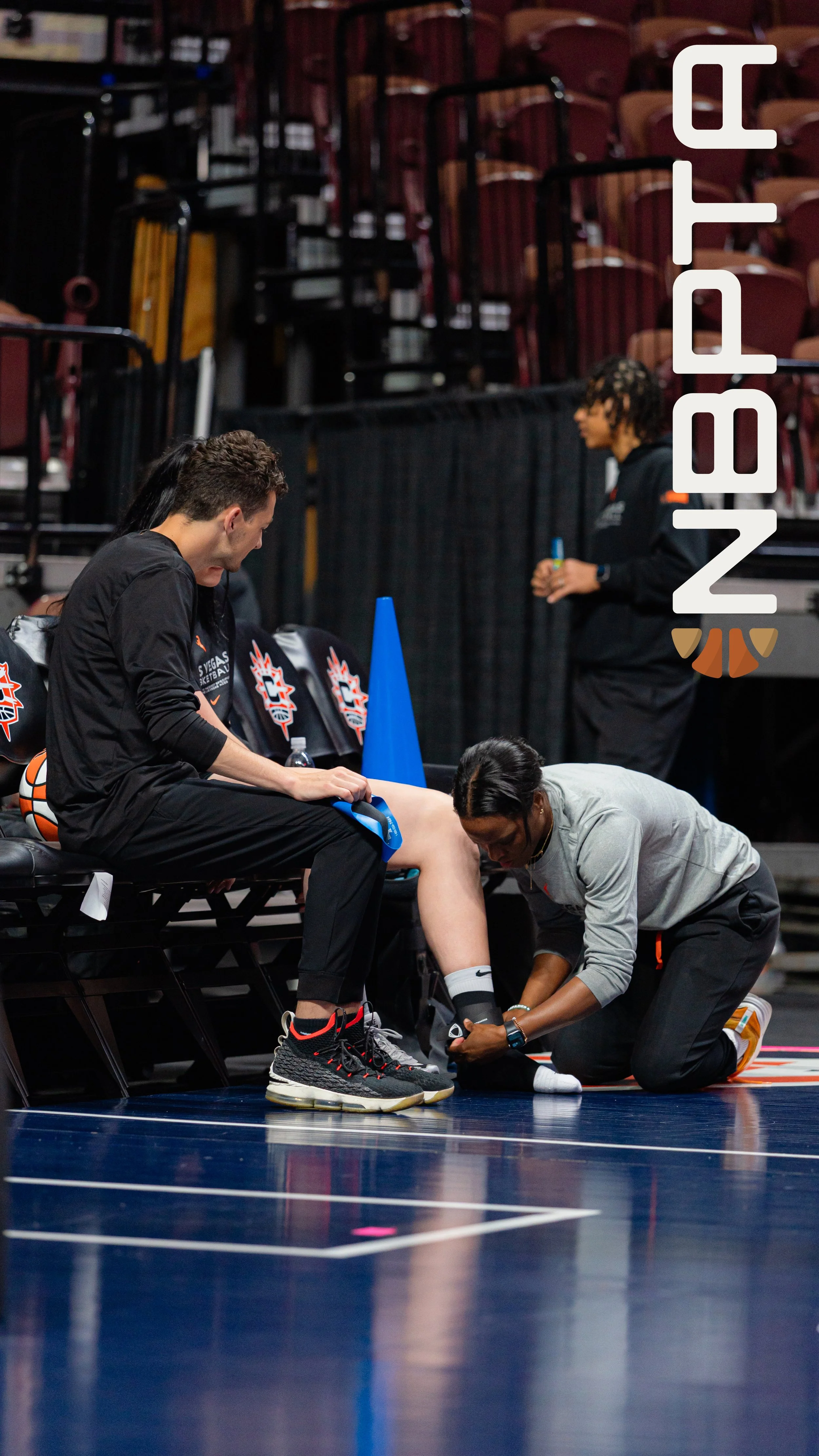 physical therapist assisting an athlete in the WNBA