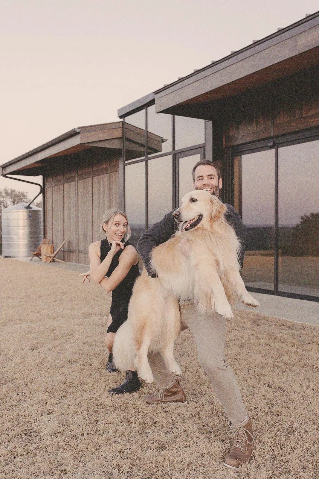 Erin and her husband Logan Kelly-Sullivan holding their dog Dave