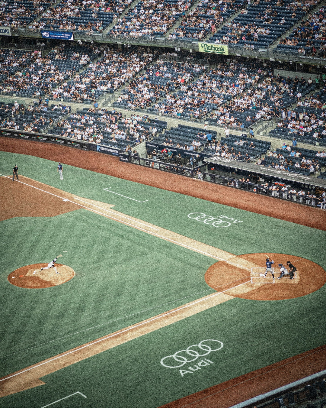 baseball field showing throwing mound and home plate with pitcher releasing ball