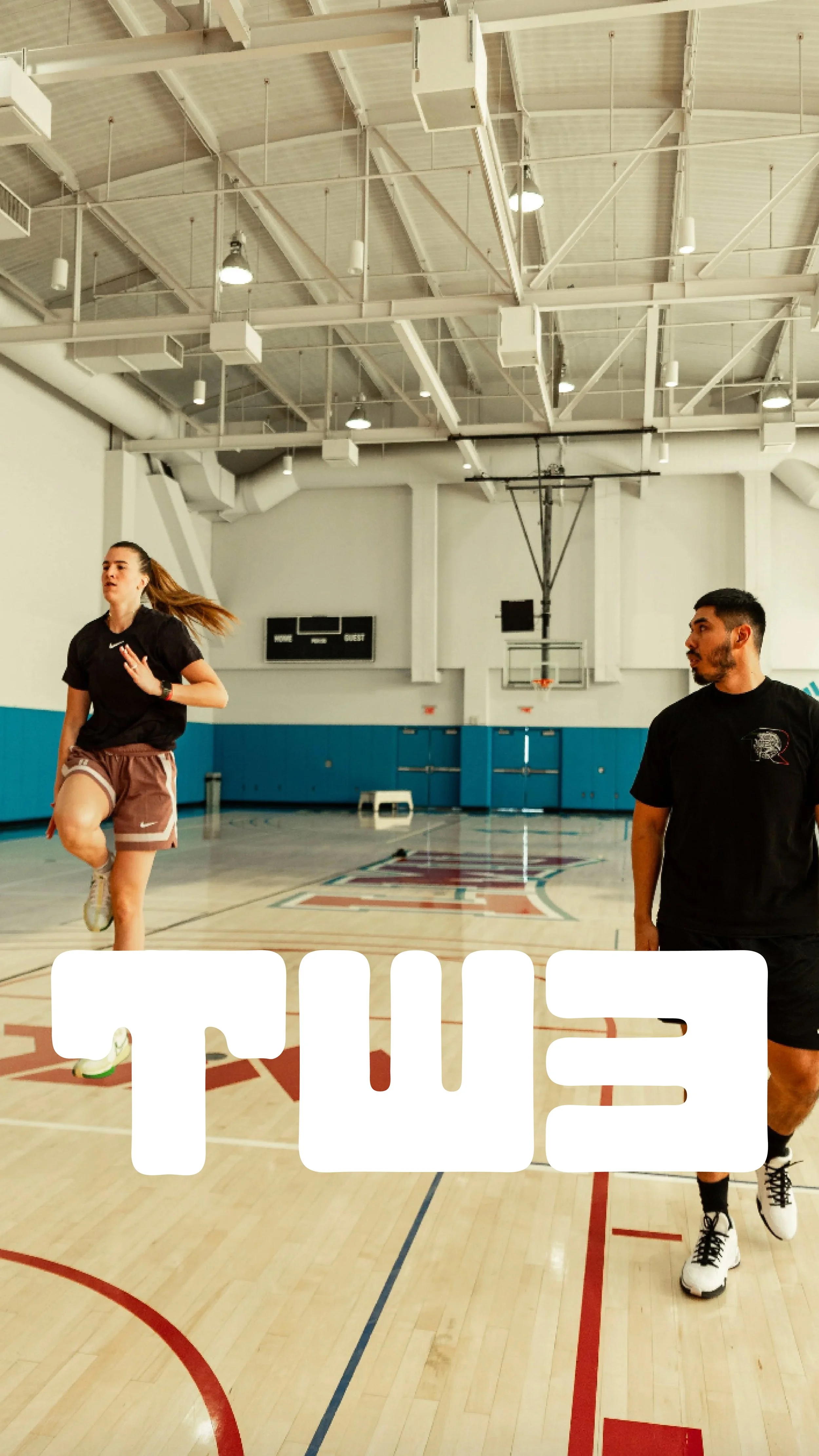 PT and athlete training in an indoor basketball court