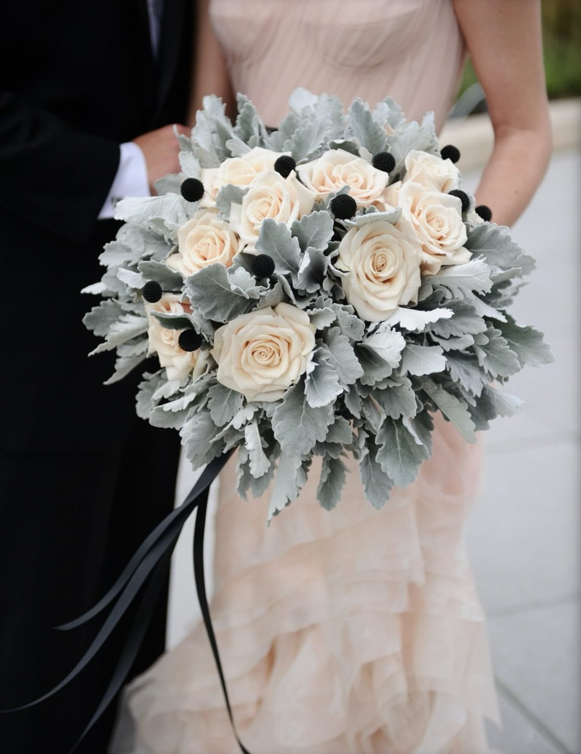 According to the Merriam-Webster dictionary, a bouquet is &ldquo;a bunch of flowers arranged attractively&rdquo;. But what if you&rsquo;re not a big flower person?

This bridal bouquet featured an abundance of dusty miller, accented with Sahara roses