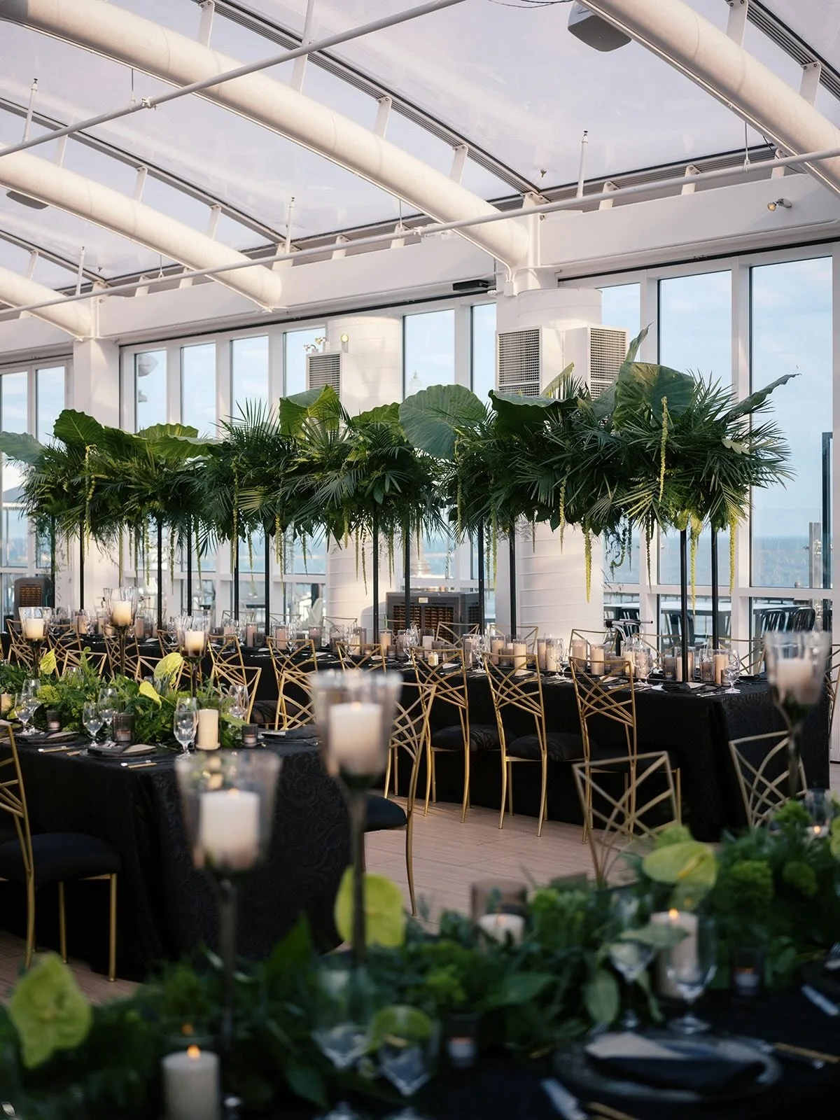 A reception can hold more than one story at once.

For Lisa and Adam, the room carried Chicago in its bones and Cura&ccedil;ao in its details. Lush greenery introduced warmth that felt rooted in family history. Black and gold gave the space structure