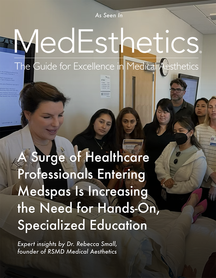 Group of healthcare professionals and students in a medical aesthetics training session, with an instructor demonstrating a procedure.