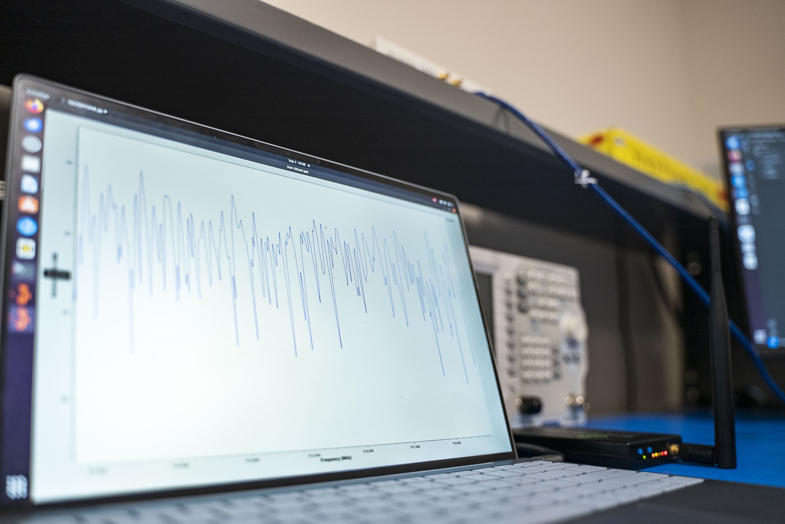 A black background with a blue line going across horizontally with a few pulses.