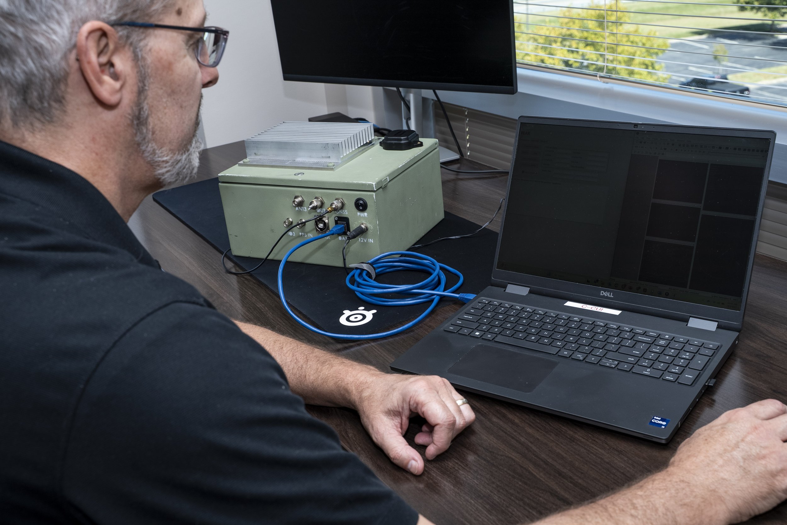 A circular logo with an animated black drone with a lightening bolt going through it, around the edge of the circle it reads "Force Electric Attack Radio, FEAR."